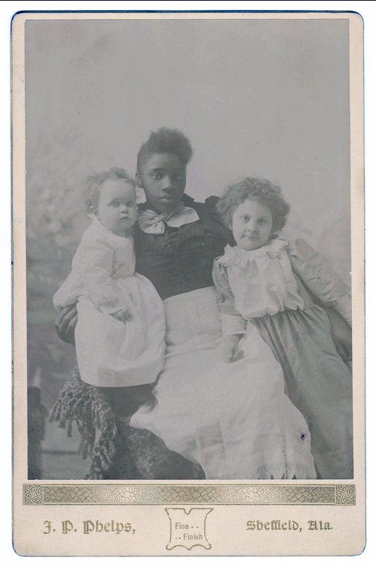 jp phelps - 1893 - Family nurse or governess sits in the middle with Helen Kellers younger sister and brother Mildred and Phillips Brooks on either side of her The nurse holds the boy